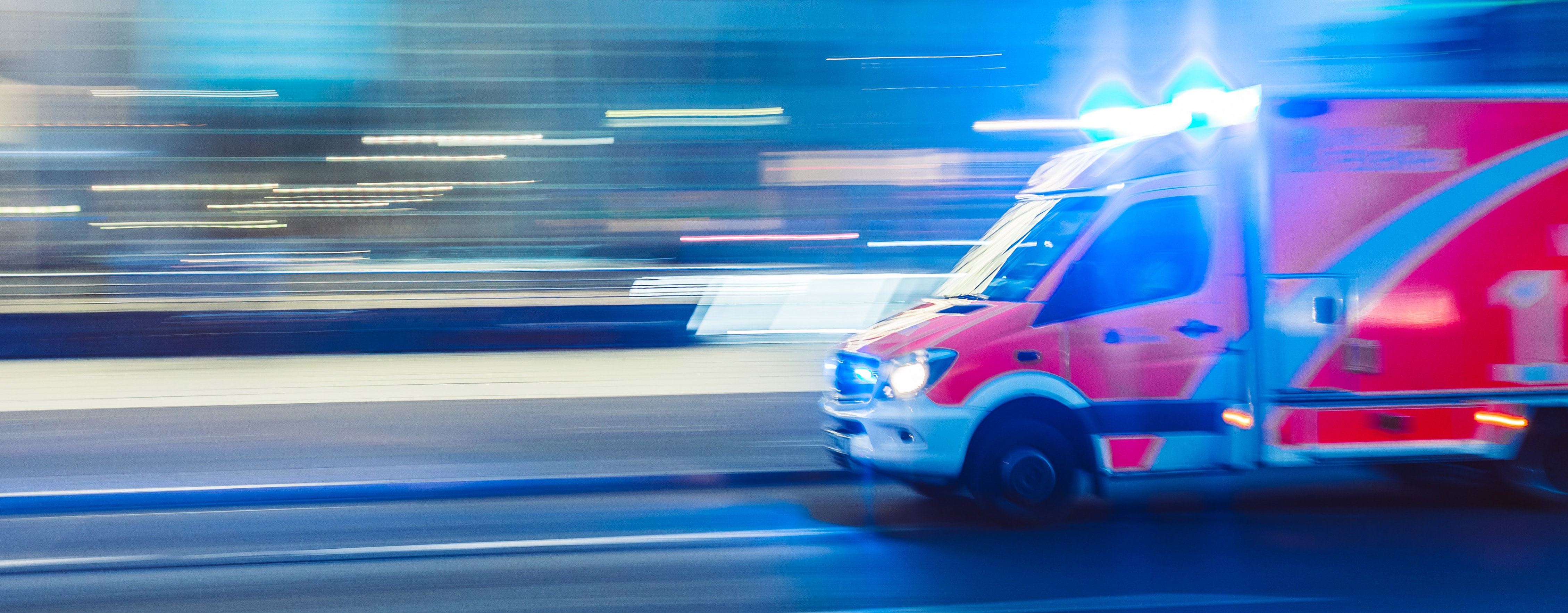 Ambulance moving down the road.