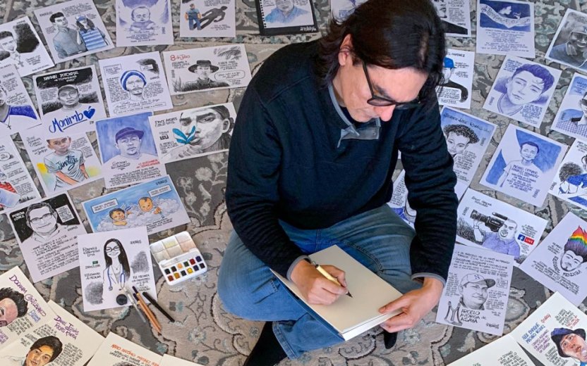 Molina sitting on the floor and sketching, surrounded by his illustrations.