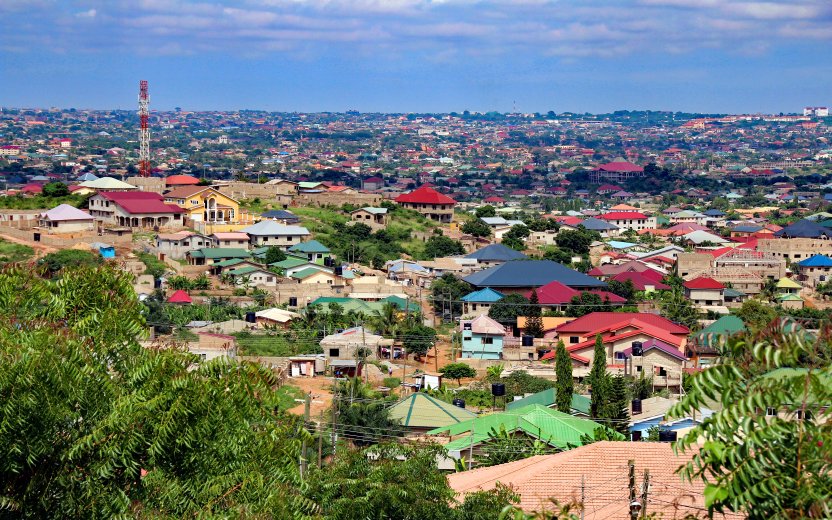 View over Accra with many colorful metal roofs on buildings
