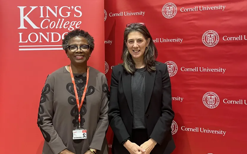 'Funmi Olonisakin (KCL) and Wendy Wolford (CU) standing in front of school banners.
