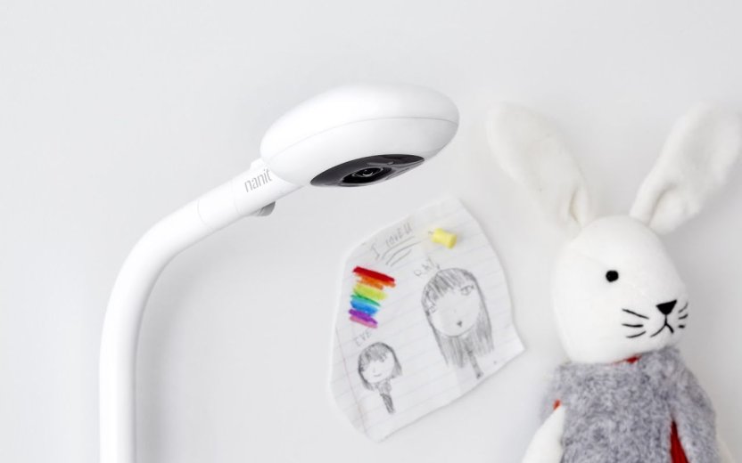 The Nanit baby monitor with stuffed bunny top in the background. 