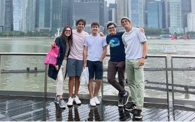 Five students standing on a pier. 