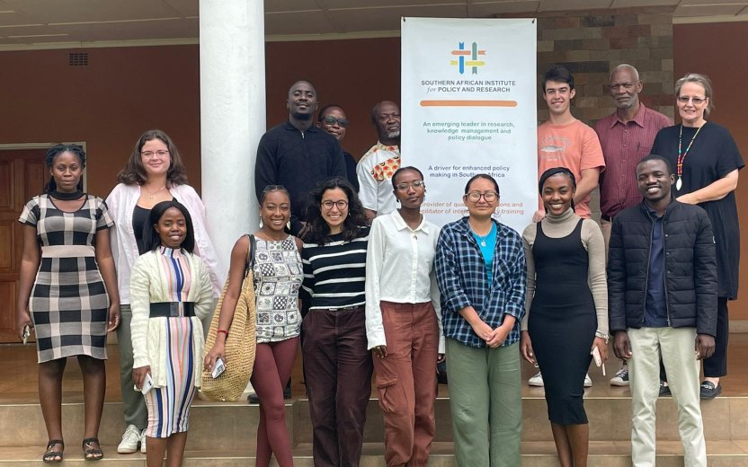Cornell students and local hosts standing in front of the Southern African Institute for Policy and Research.