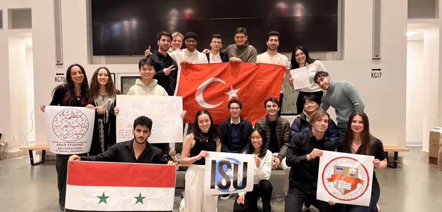 Members of student groups holding flags of their homelands.