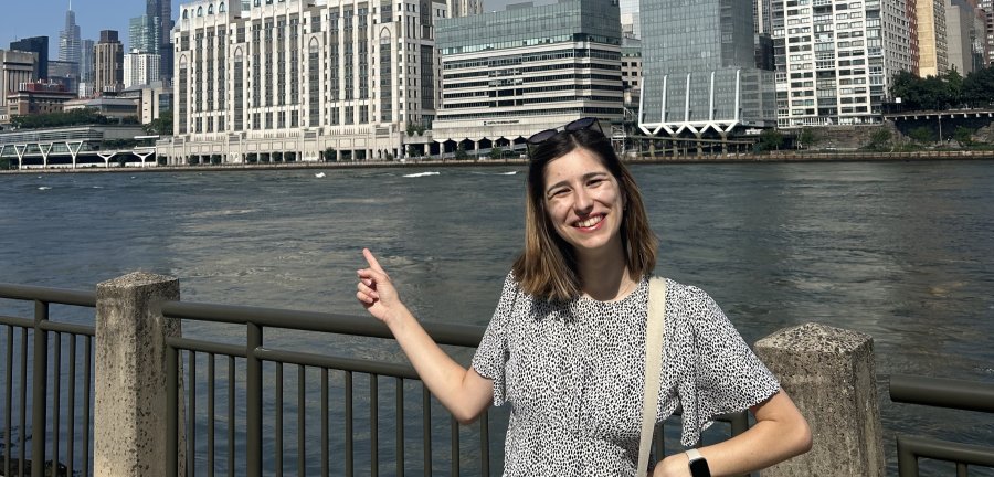 Ioana Esanu smiles and points to the city behind her.