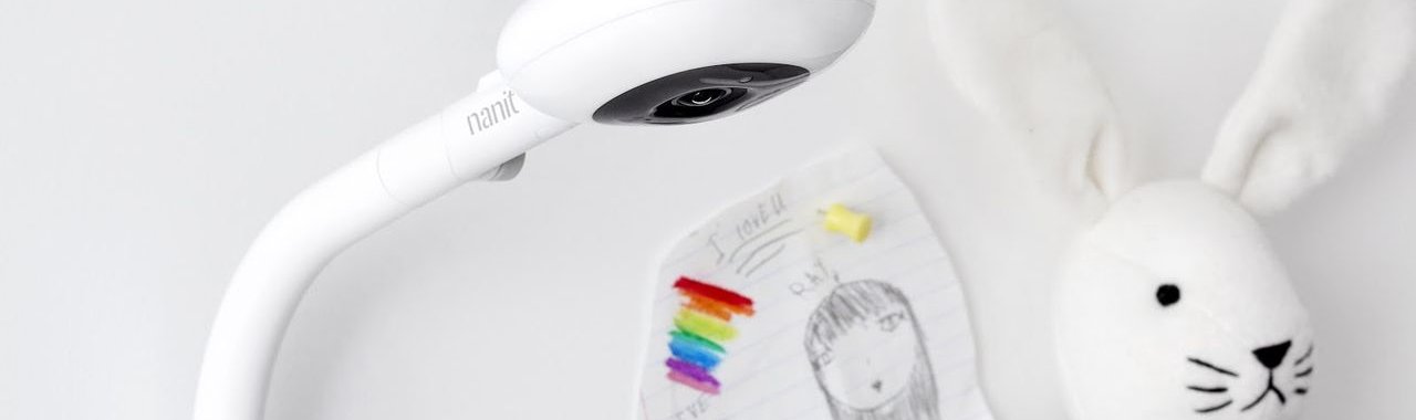 The Nanit baby monitor with stuffed bunny top in the background. 