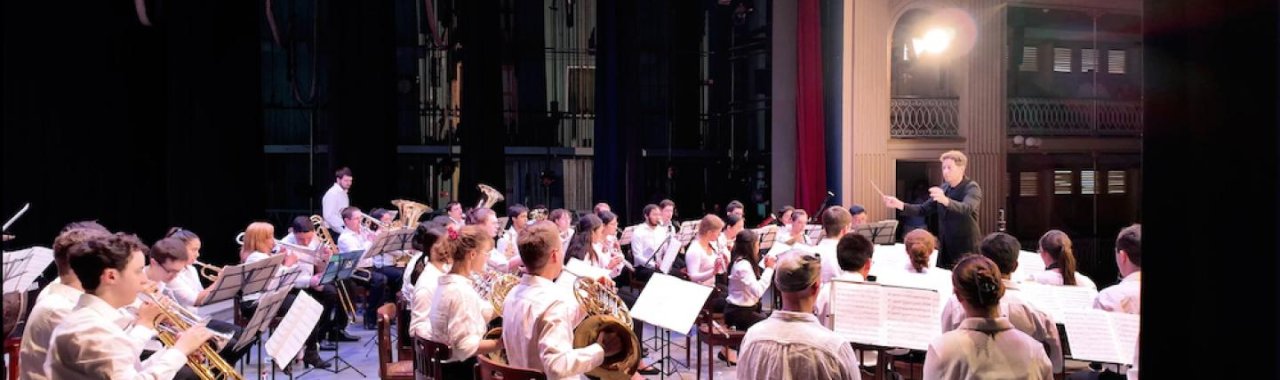 Cornell's student orchestra practicing with their conductor