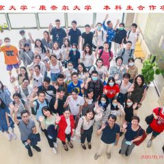 Overhead view of students standing in a group waving.