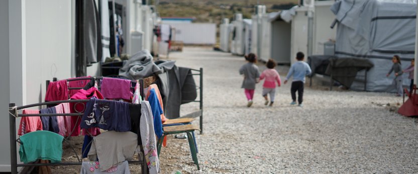 Young children working through migrations camp.