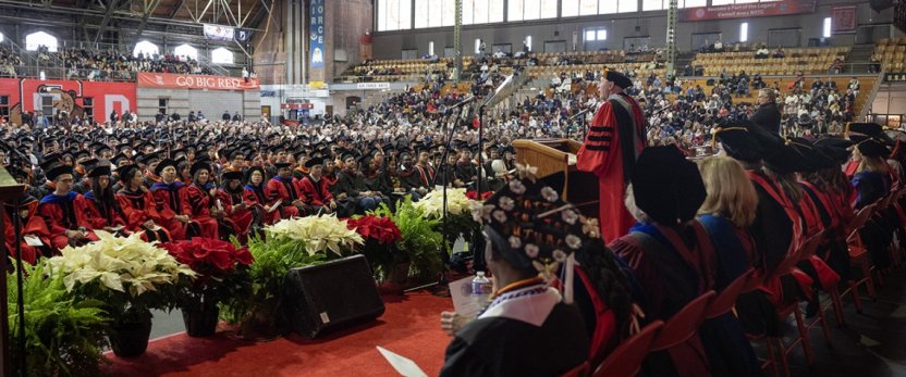 View of Interim President Kotlikoff at the podium speaking to a crowd in Barton Hall. 