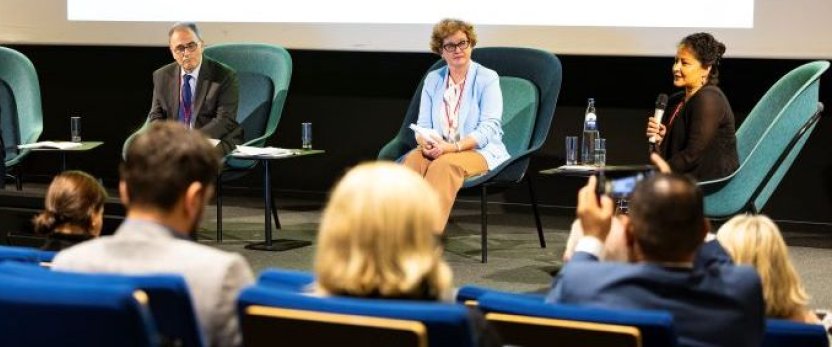 A four-person panel with Nishi Dhupa on the right, in front of an audience. 