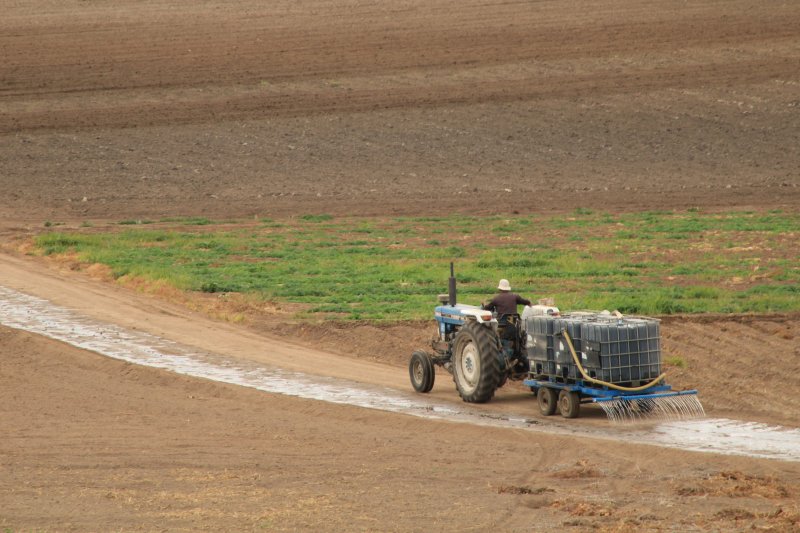 Tractor spraying field