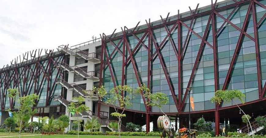 Exterior of building with iron lattice over the windows resembling a tree.