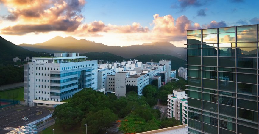 Skyline view of HKUST campus with glass building in foreground.