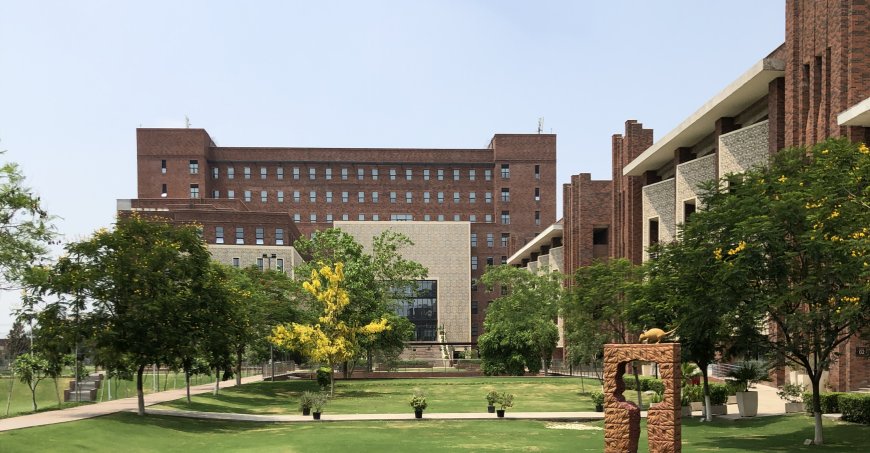 Ashoka campus with red brick buildings alternating with a lighter lattice facade