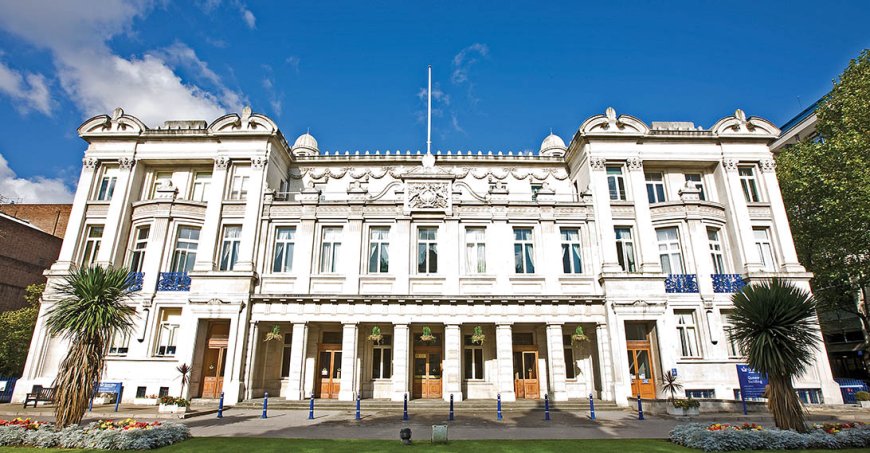 Multi-story, white building with columns