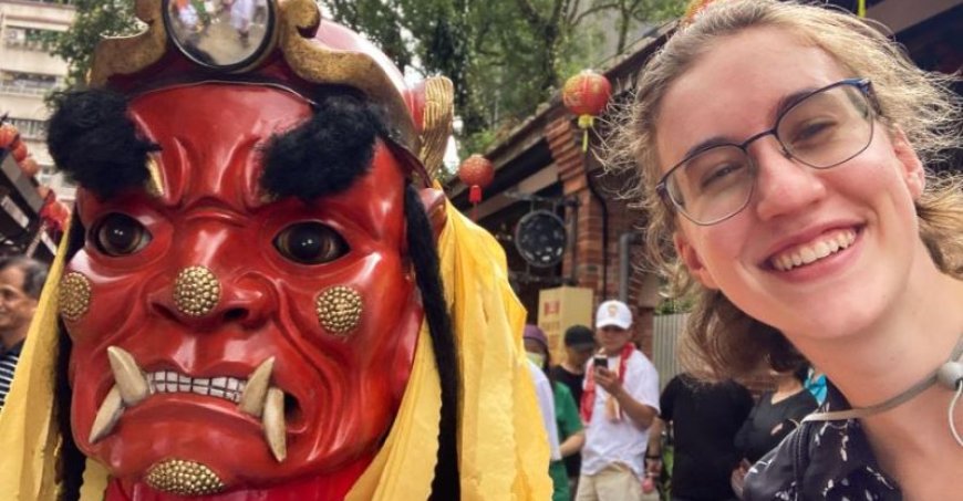 McKenna Norton posing next to a red-faced statue.