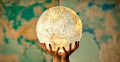 Hands holding globe