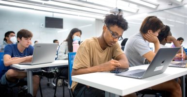 Students sitting in rows in a classroom.