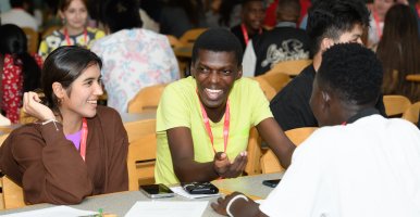 Students sitting around a table during the Prepare orientation event.