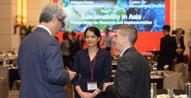 People at the Sustainability in Asia conference talking during a break.