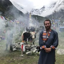Student stands in ceremony in Nepal.