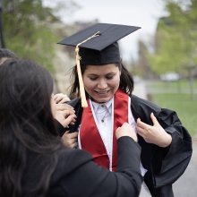 Khadija Monis being helped into her graduation robes.