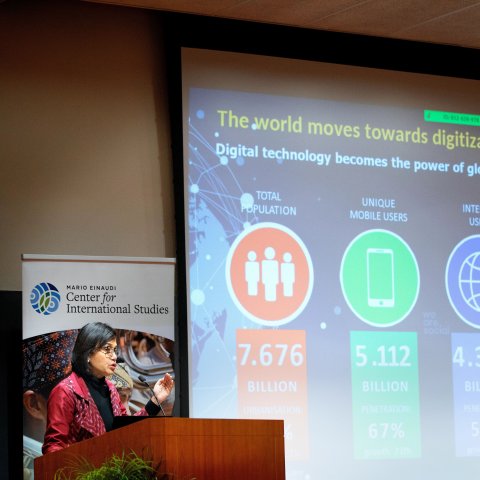 Speaker at lectern, with screen to the right.