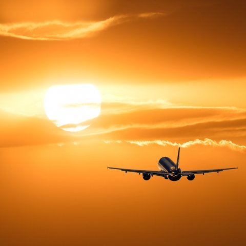 Airplane in the sky at sunset