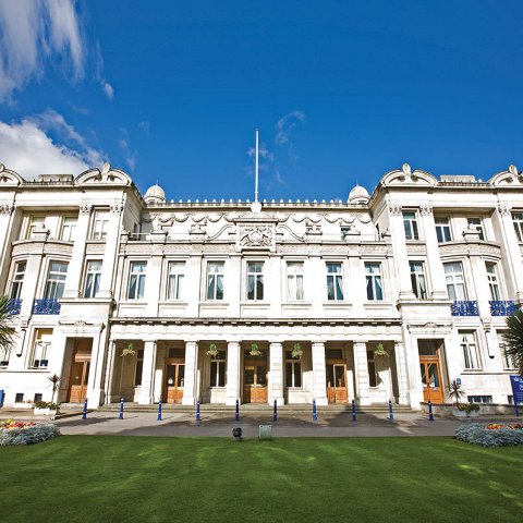 Multi-story, white building with columns